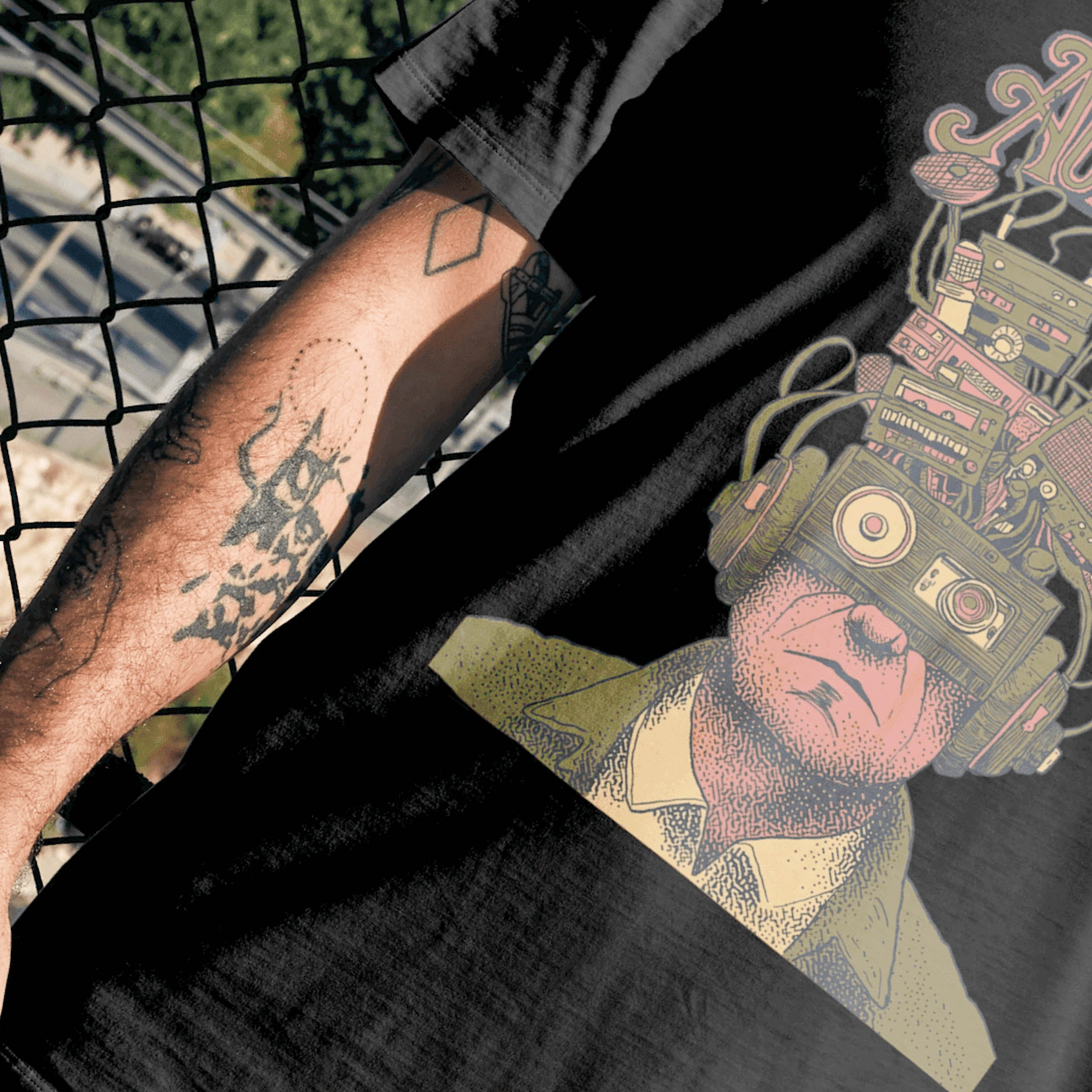 Black T-shirt detail showing an Audiohaze cassette and audio gear illustration on fabric